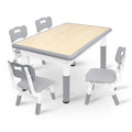 Una mesa acompañada de cuatro sillas, con un diseño de altura ajustable, ideal para una oficina y una mesa de aula que es fácil de limpiar.